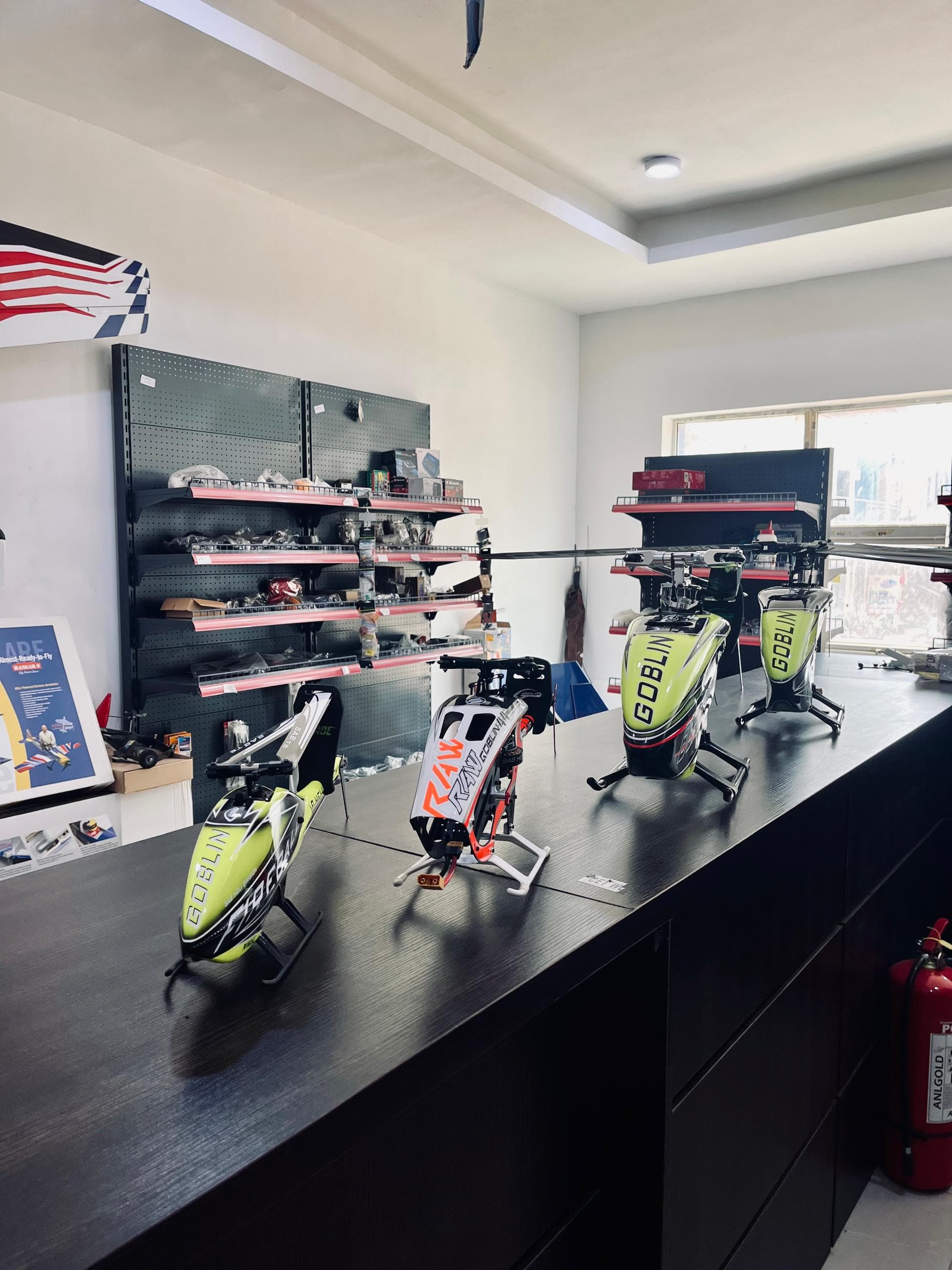 RC helicopters displayed on the counter at the Mekatron Flyers shop